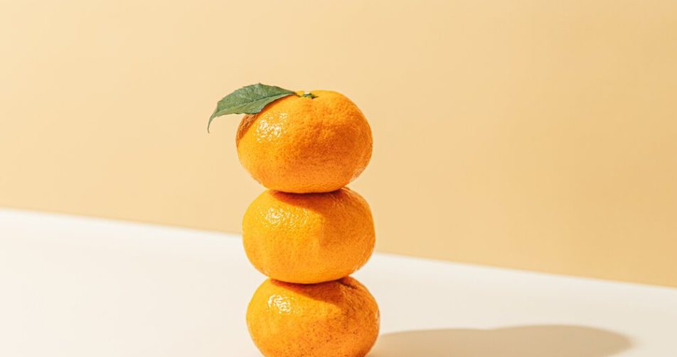 Stack Of Mandarin Oranges With Leaf